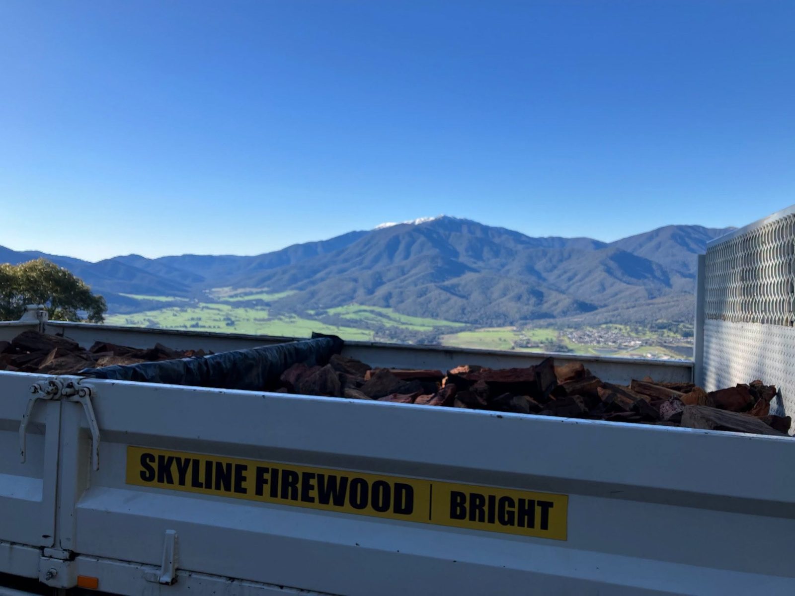 A Skyline Firewood ute loaded with split redgum above the Bright valley